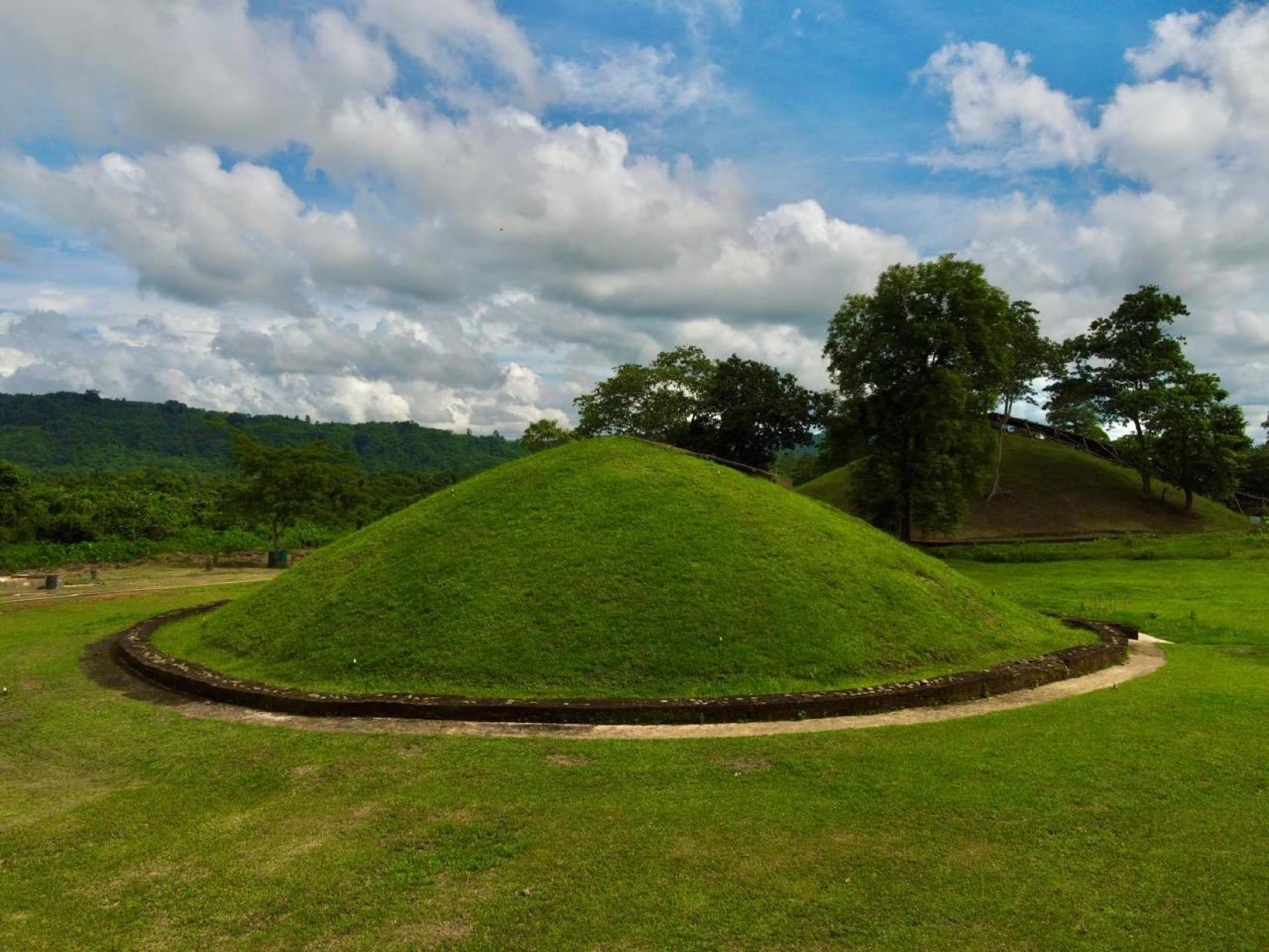 Each moidam consists of an earth mound built over a hollow vault constructed of brick, stone, or earth, and is topped by a shrine at the center of an octagonal wall.