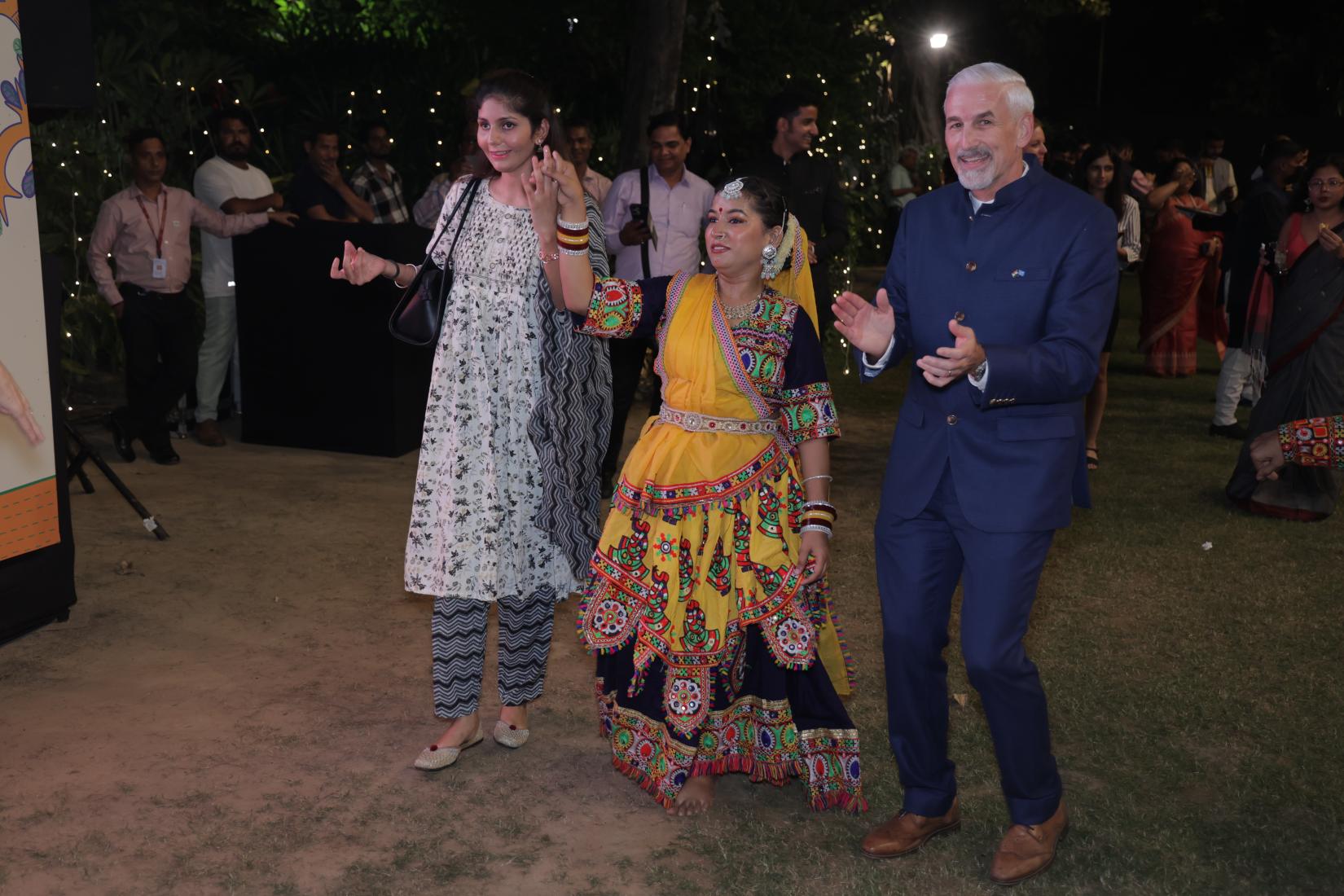 UN in India Resident Coordinator Shombi Sharp and guests at the UN Day celebrations in New Delhi shake a leg with garba dancers. 