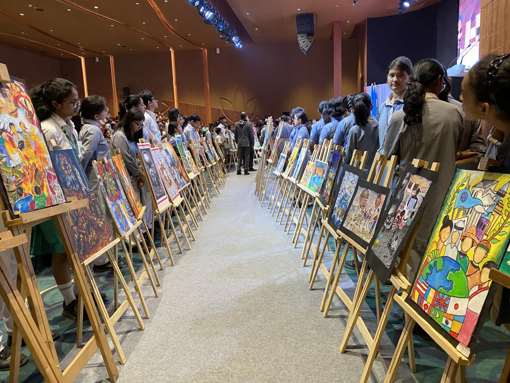 Artwork from schoolchildren line the hall at Bharat Mandapam in New Delhi at the commemoration of the 31st anniversary of the genocide against the Tutsi in Rwanda. 