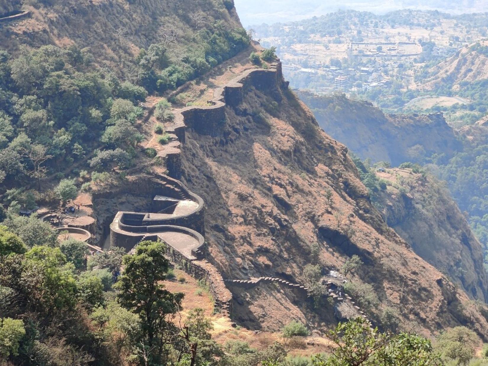 The escapments of the Rayri hill and fortification wall integrated with the curved, concealed gateway in Raigad. 