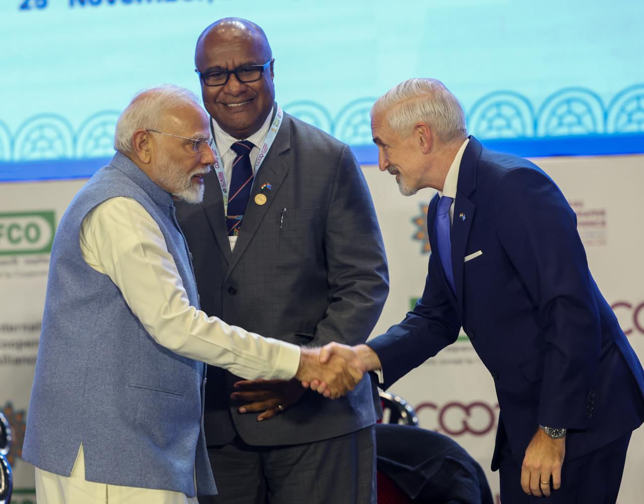 Indian Prime Minister Narendra Modi and United Nations in India Resident Coordinator Shombi Sharp interact at the launch of the UN International Year of Cooperatives 2025 in New Delhi as Fiji Deputy Prime Minister Manoa Kamikamica looks on. The launch marks the beginning of a year dedicated to recognizing the role of cooperatives in achieving the United Nations Sustainable Development Goals.