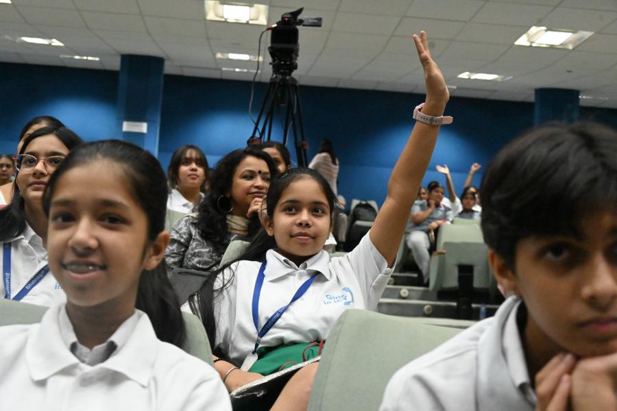 A participant raises her hand at the International Telecommunication Union's India launch of the Girls in ICT flagship initiative
