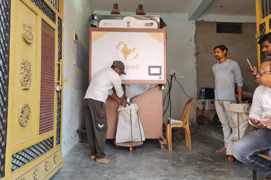 Person filling sack from Grain ATM